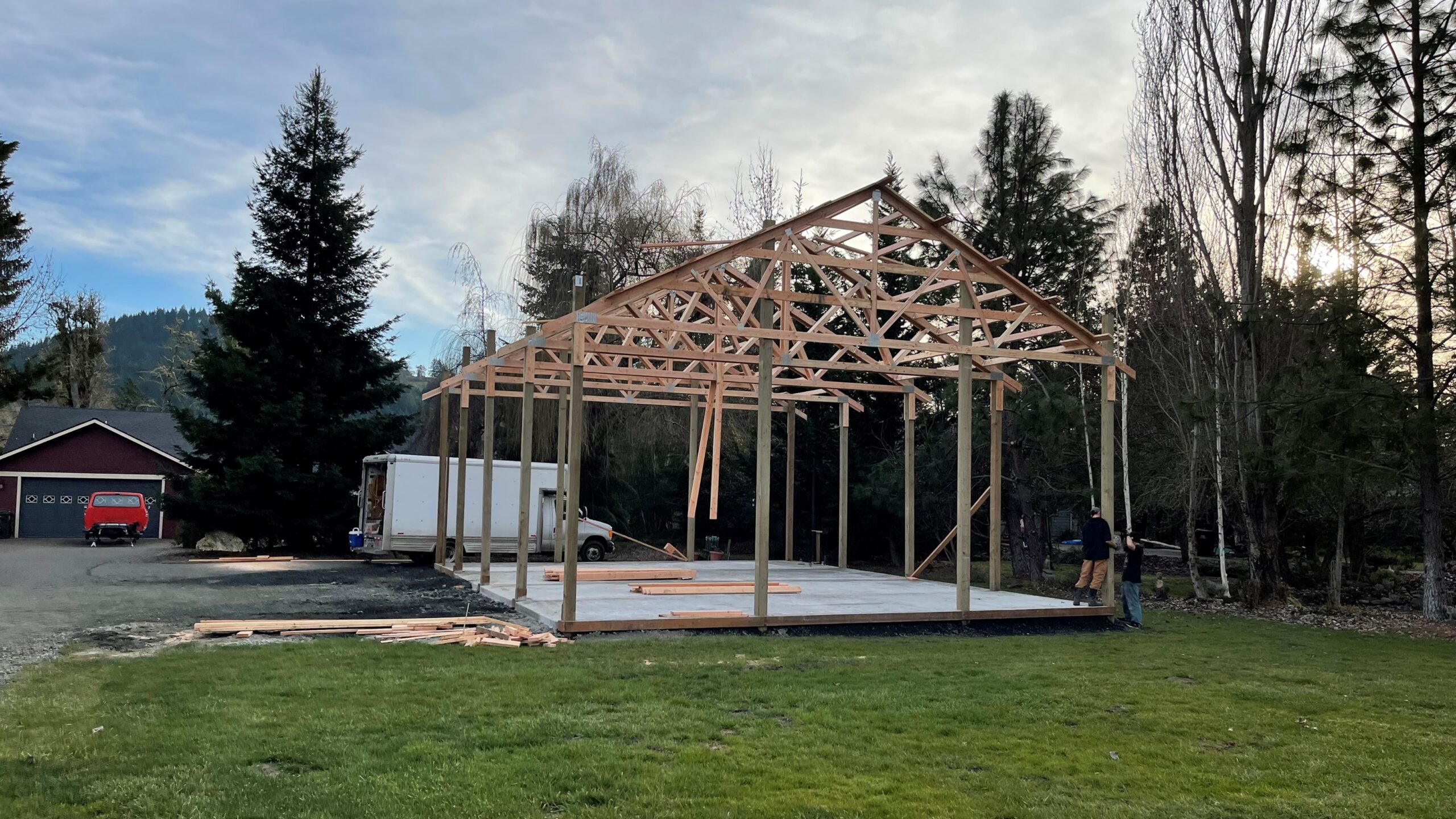 Post frame structure framed on a finished concrete slab