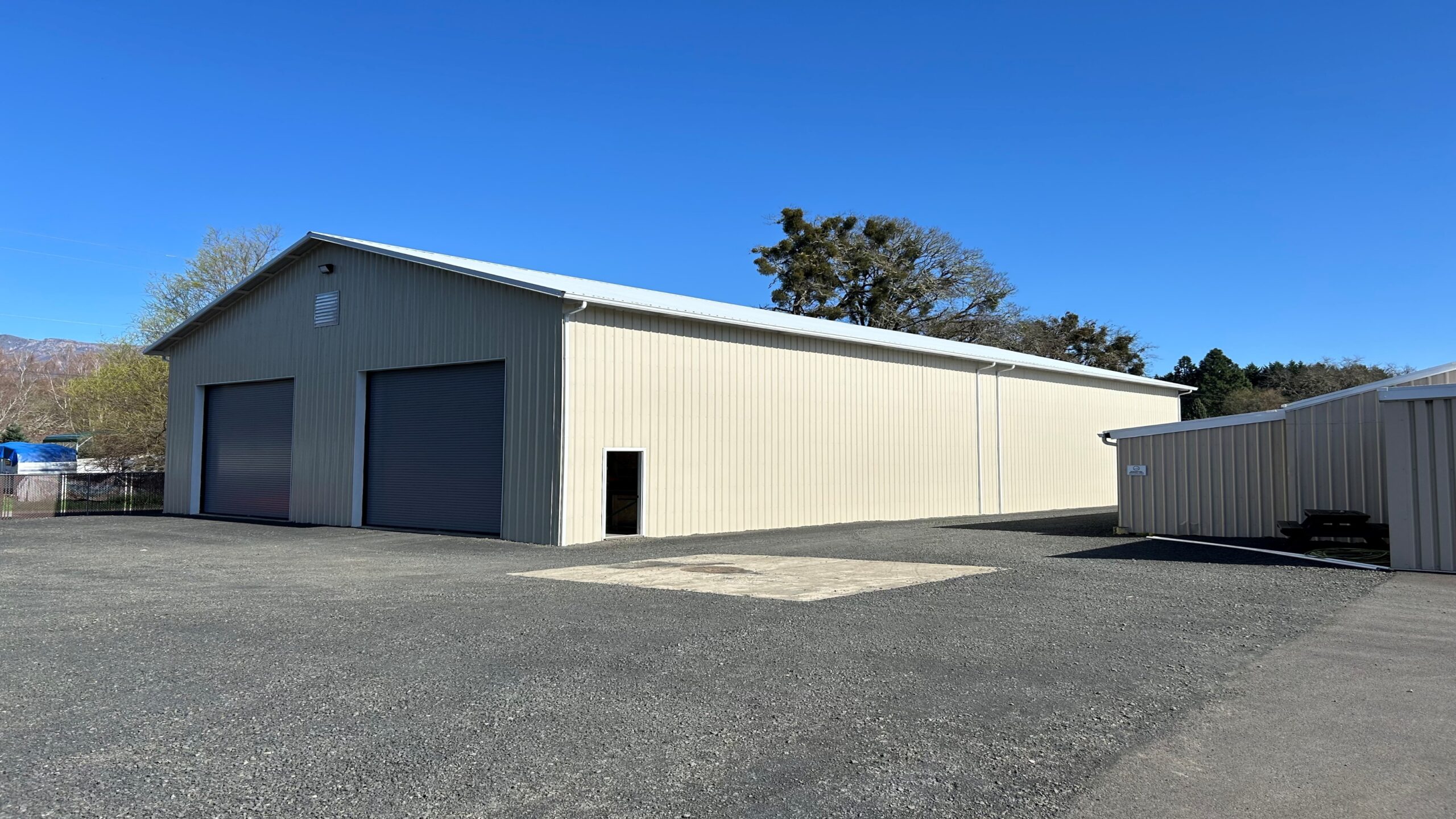 Large grey commercial post frame building