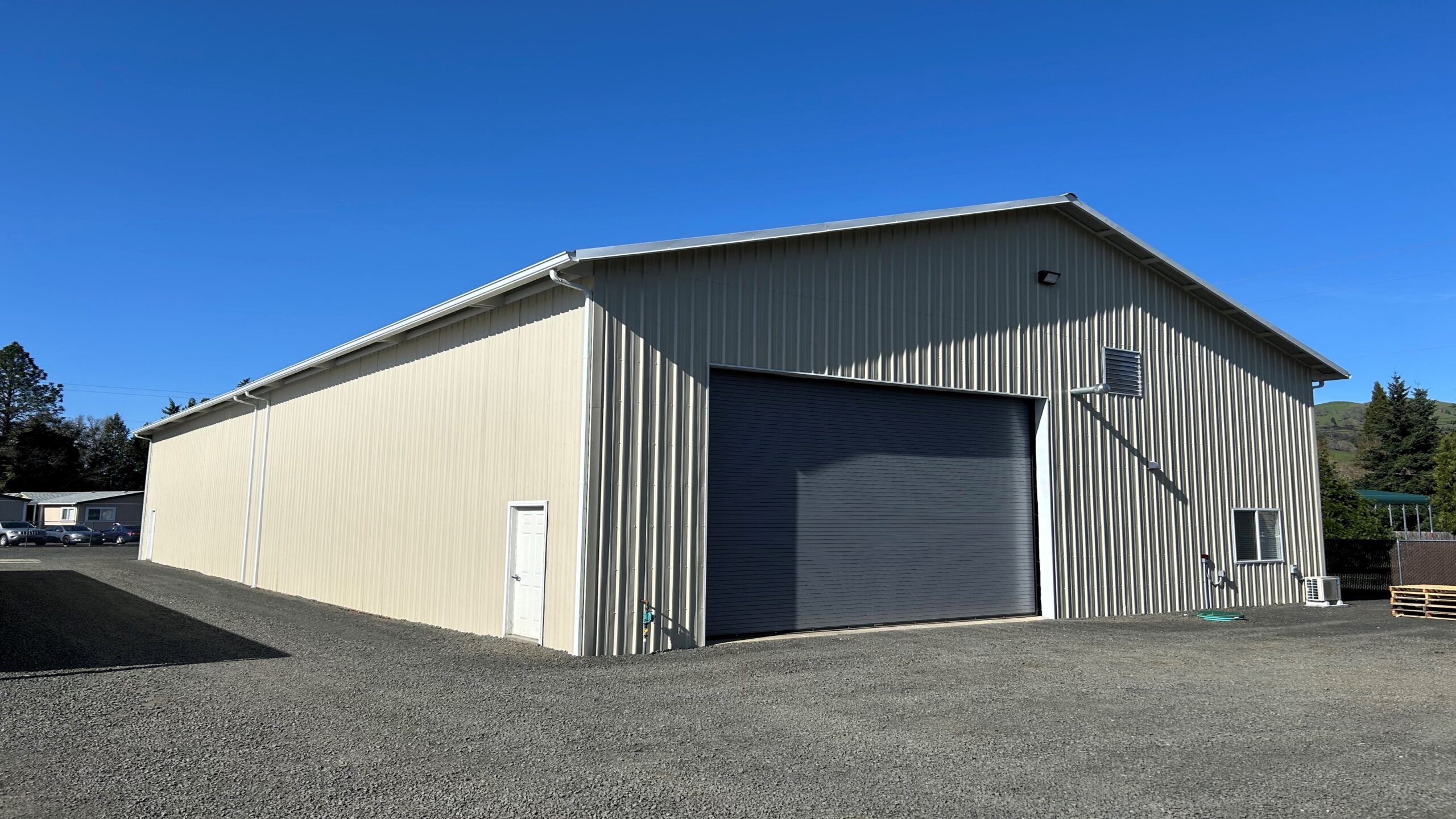Tan post frame shop building
