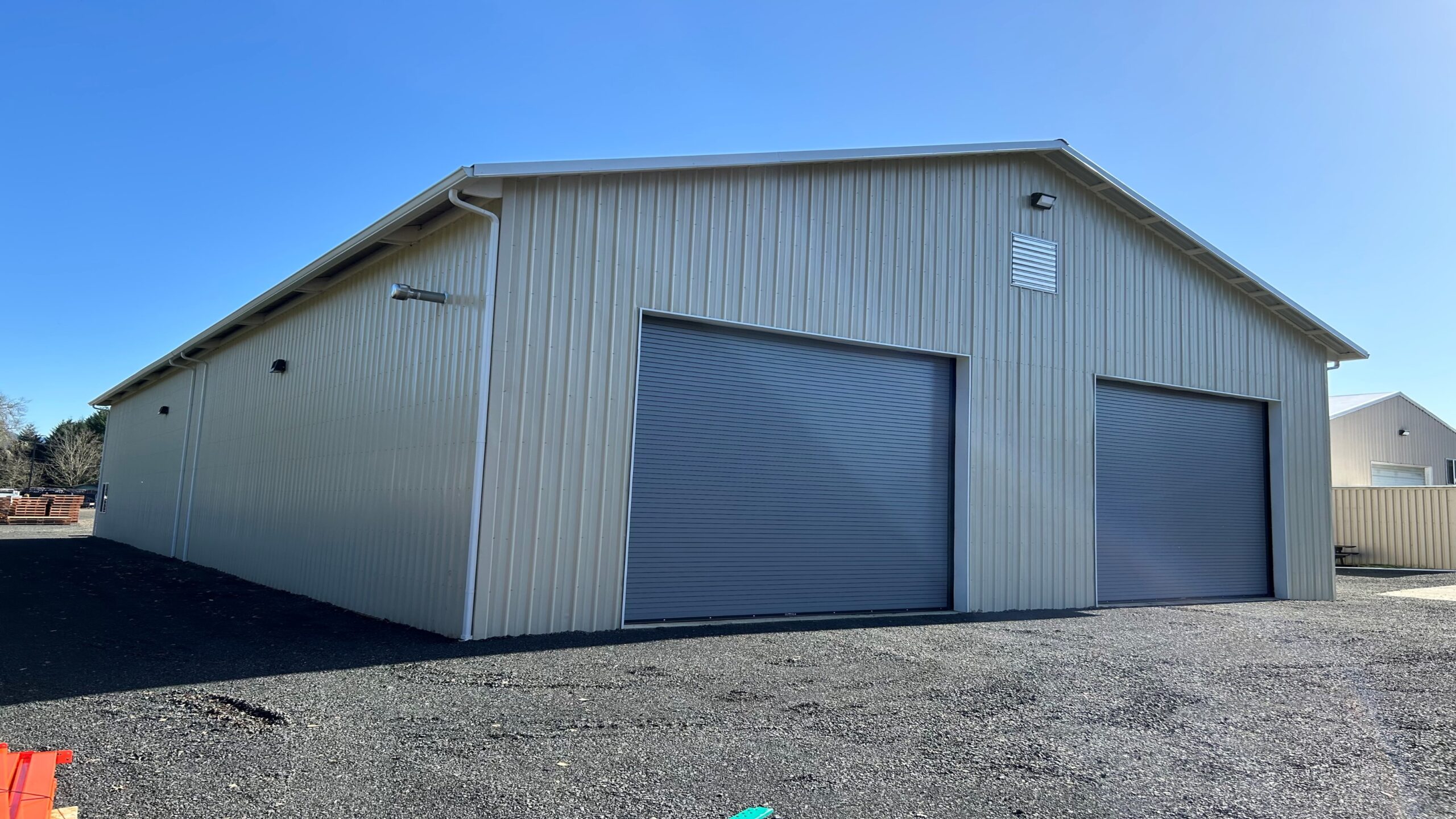 Grey shop with blue roll up doors